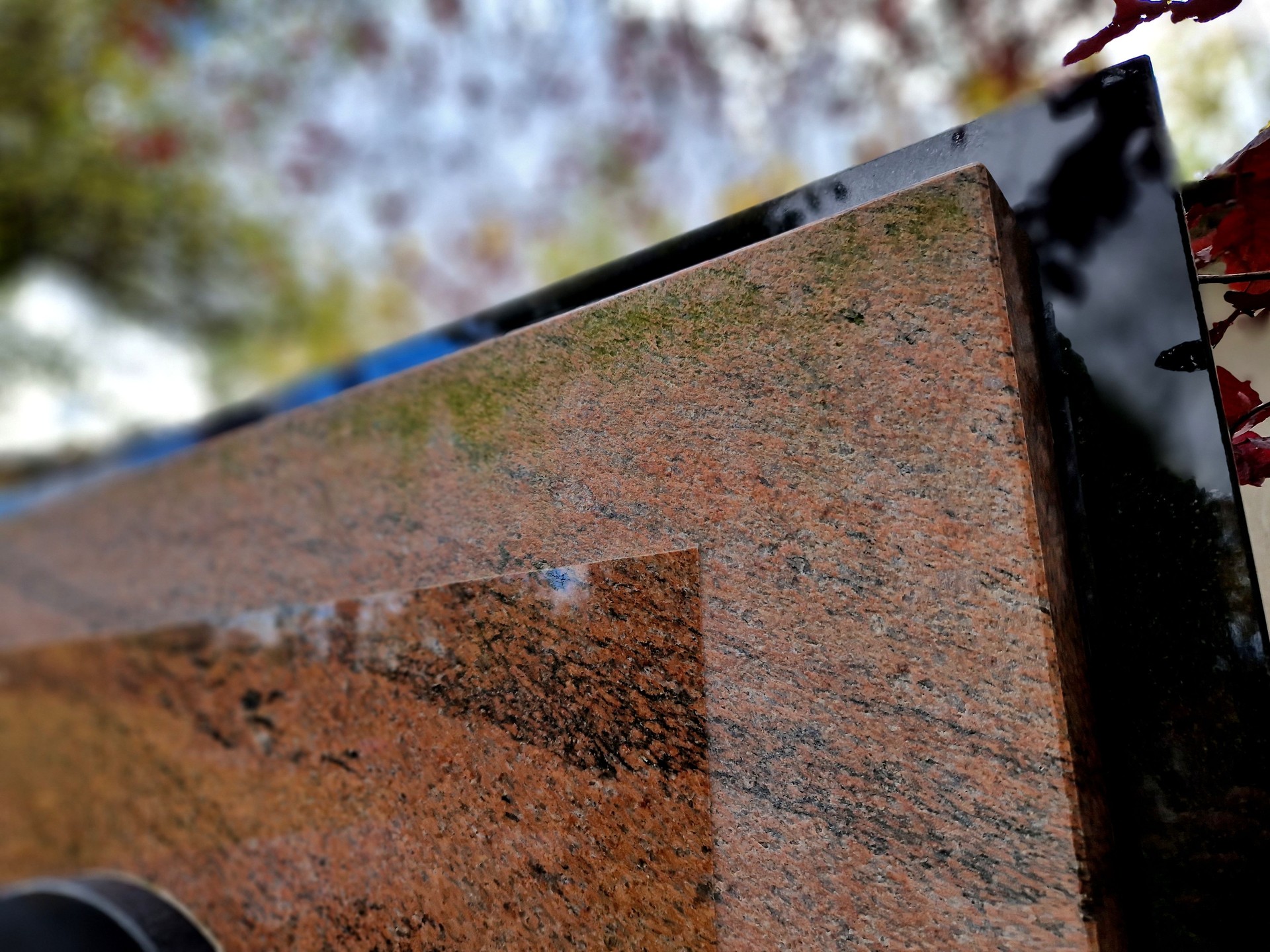 roughness, production of tombstones on customer request. execution of polishing the surface of the stone slab in different roughnesses, smoothed part and rough-machined grains. mason's workshop, gravedigger,